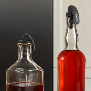 Zyliss Easy Seal bottle stopper sealing an open soft drink bottle on a kitchen bench