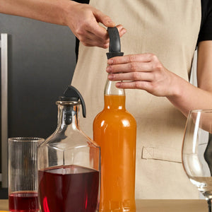 Zyliss Easy Seal bottle stoppers in use keeping sparkling water fresh