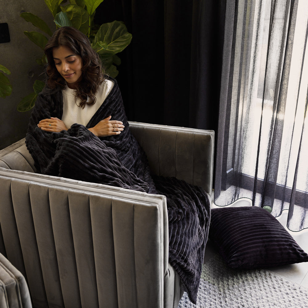 Bambury Channel Throw 150x200cm Charcoal - draped on sofa lifestyle shot
