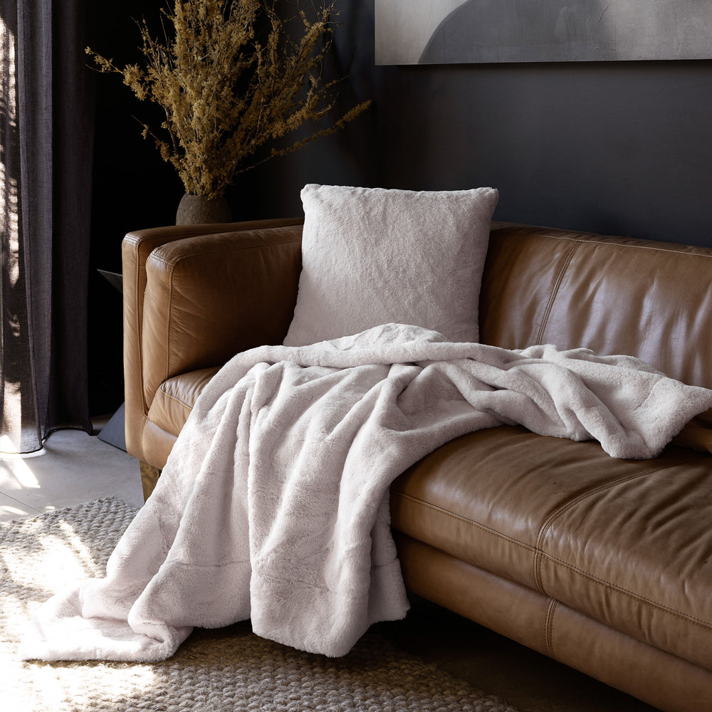 Bambury Frida Faux Fur Cushion Snow - styled on sofa