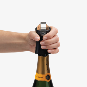 Champop fitted over a champagne cork ready to pop