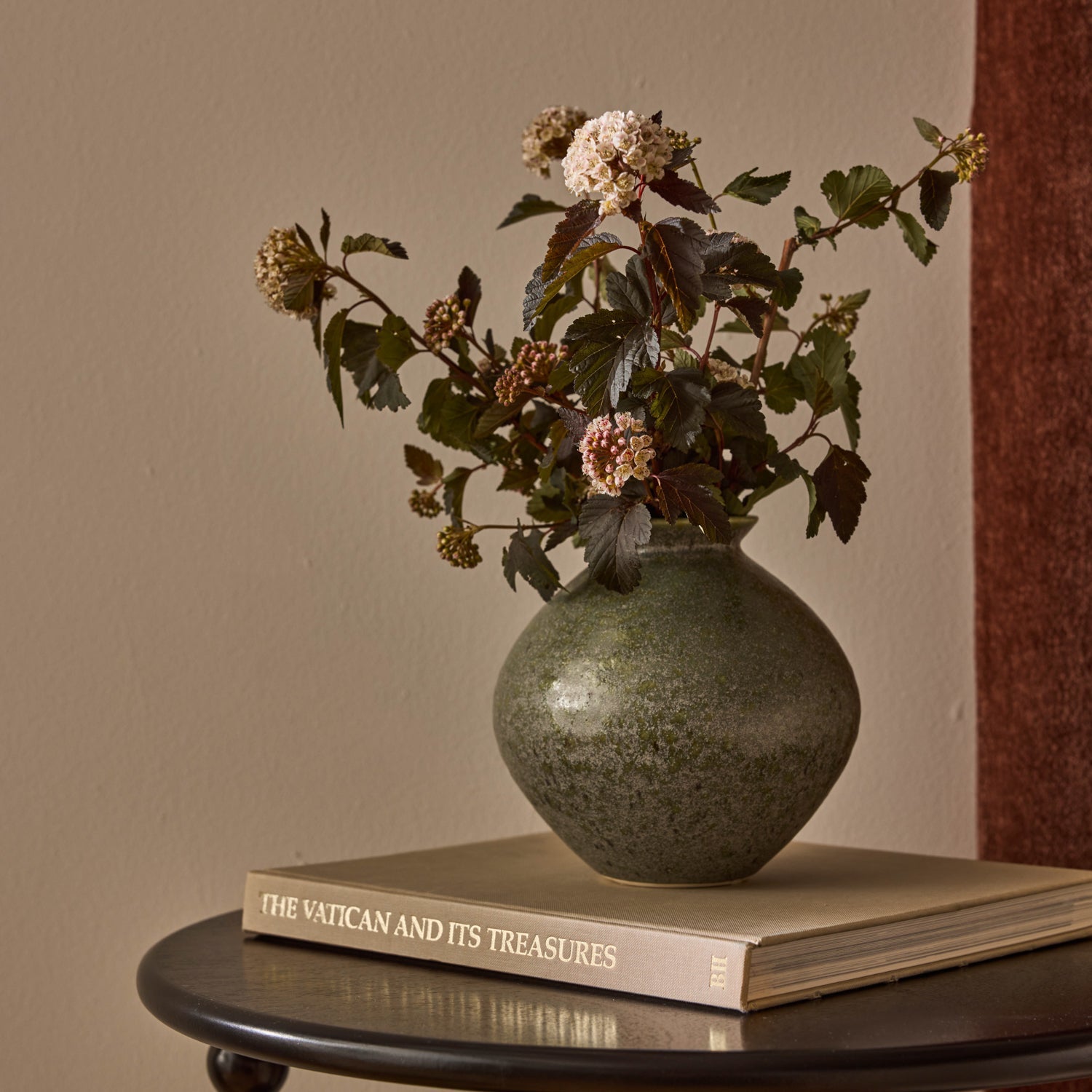 Hans dark green vase styled with dried stems