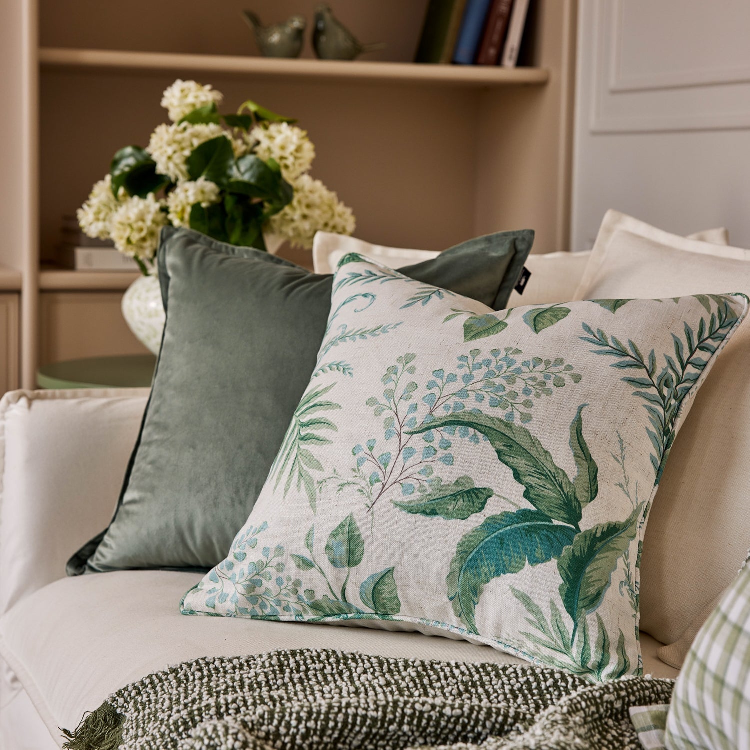 Madras Link Fern Blue Green Cushion 50cm - styled on sofa